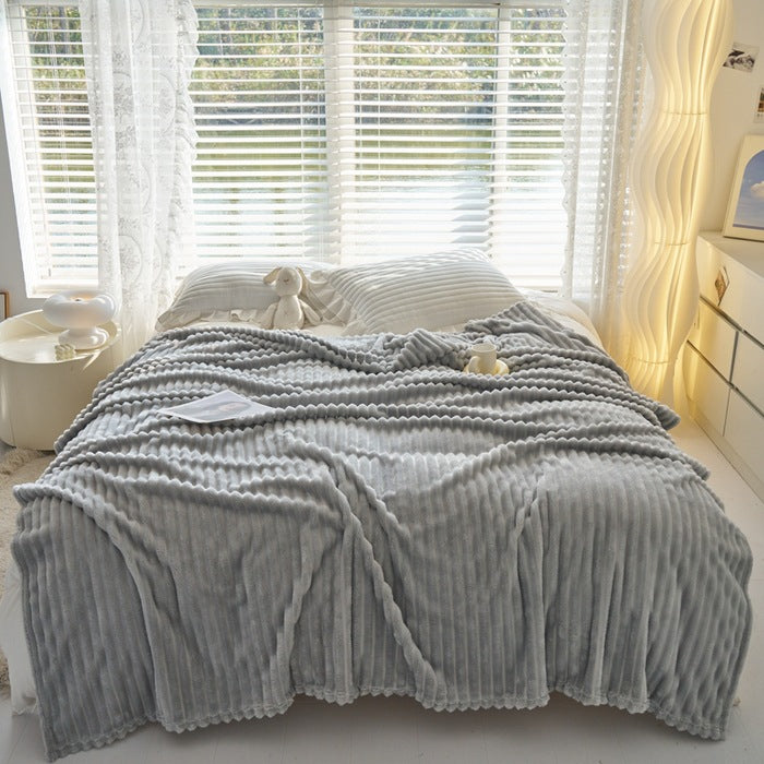 Ribbed faux rabbit fur blanket on bed