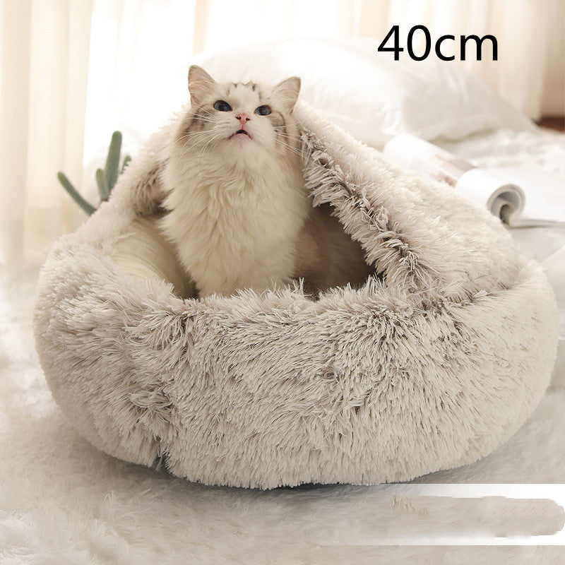 Cat curled up in a round plush bed with hood