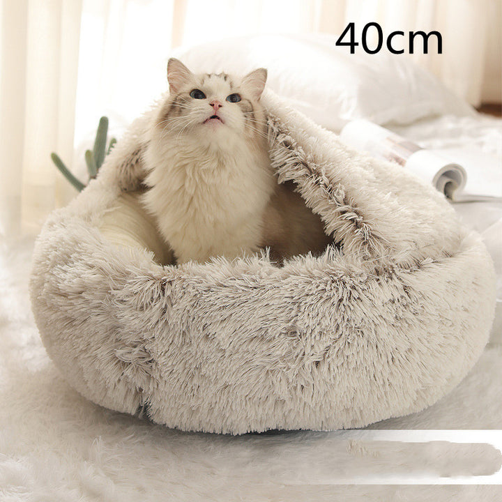 Cat curled up in a round plush bed with hood