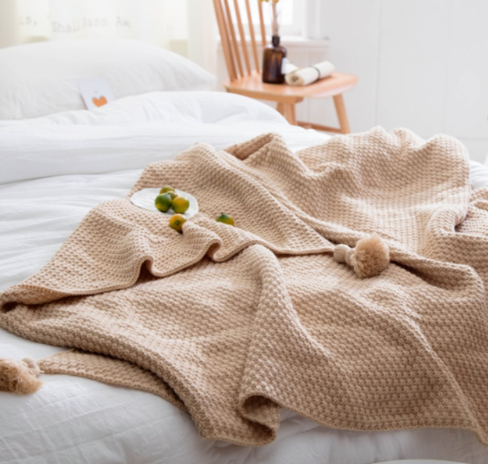 Waffle knit throw with pom-pom fringe