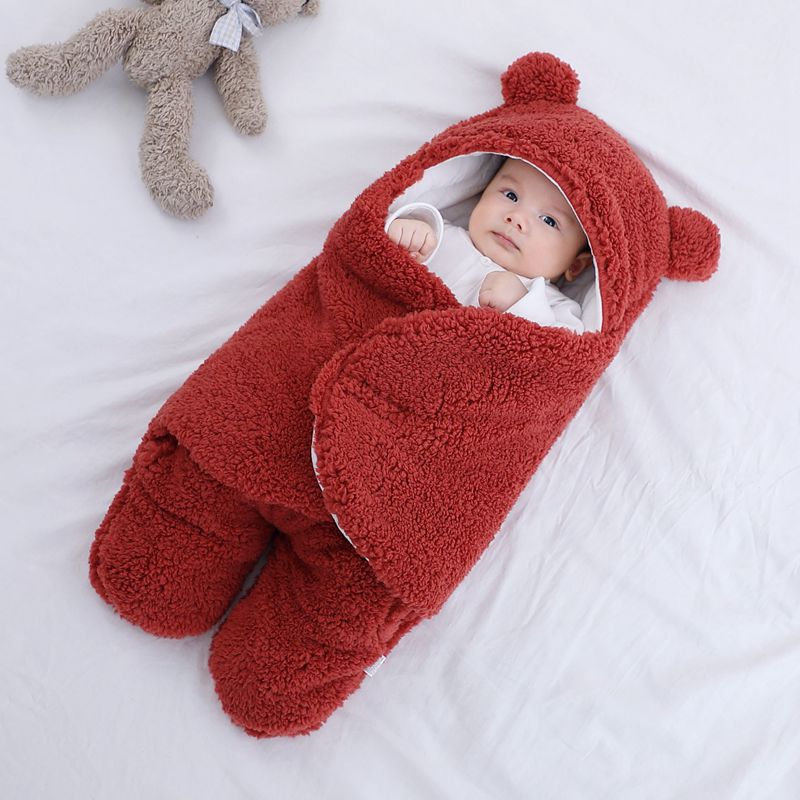 Baby in a plush bear-ear hooded wrap