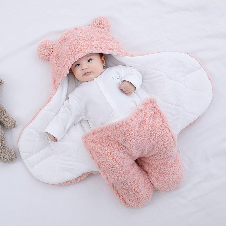 Baby in a plush bear-ear hooded wrap
