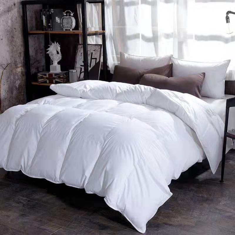 Quilted winter comforter on a made bed