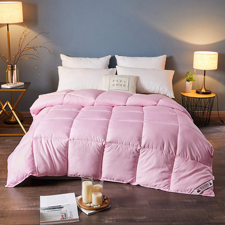 Quilted winter comforter on a made bed