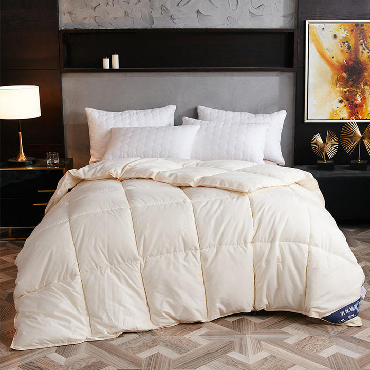 Quilted winter comforter on a made bed