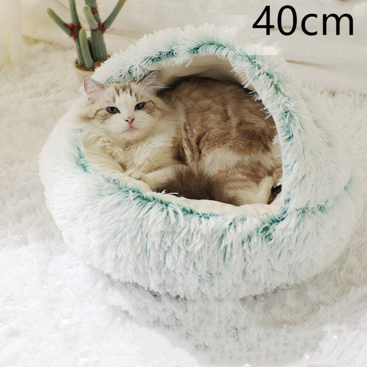 Cat curled up in a round plush bed with hood