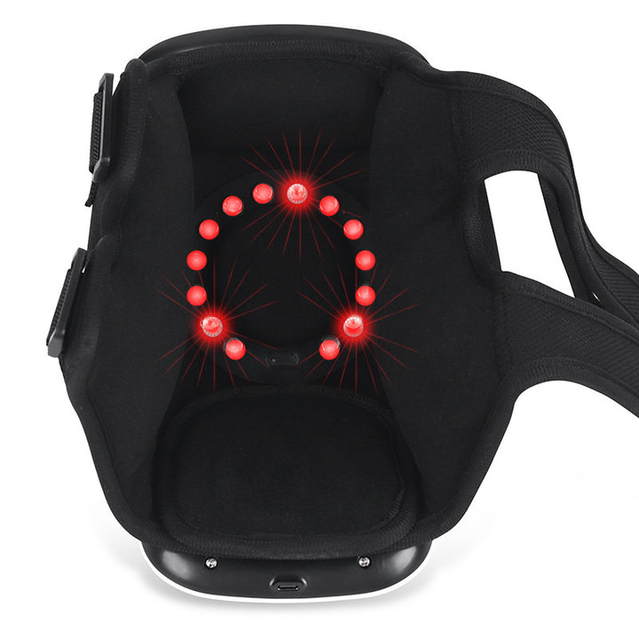 White wearable knee massager wrapped around a knee