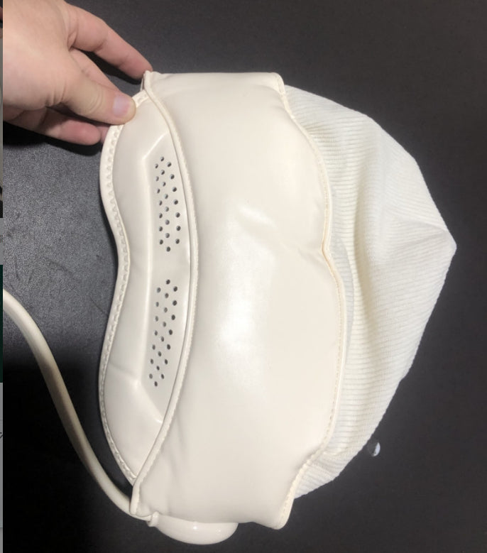 Person wearing a hooded head and eye massager