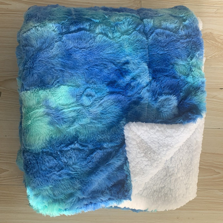 Thick sherpa fleece throw on a sofa