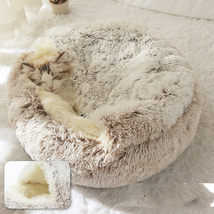 Cat curled up in a round plush bed with hood