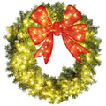 Large lighted Christmas wreath with red bow