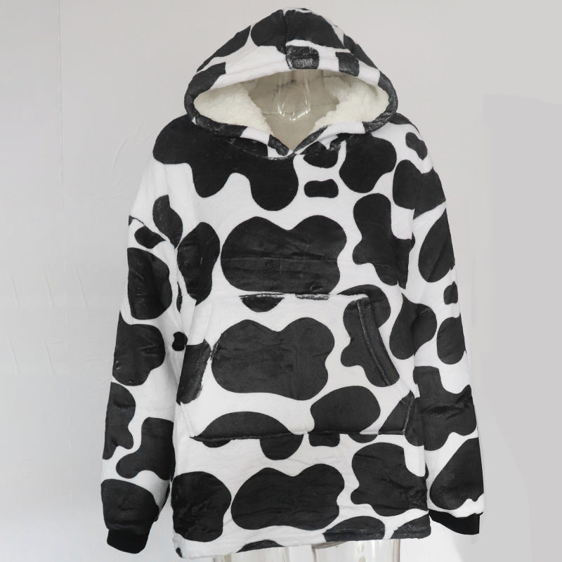 Person wearing oversized hooded blanket