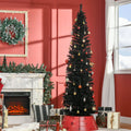 Slim black pencil Christmas tree in a living room