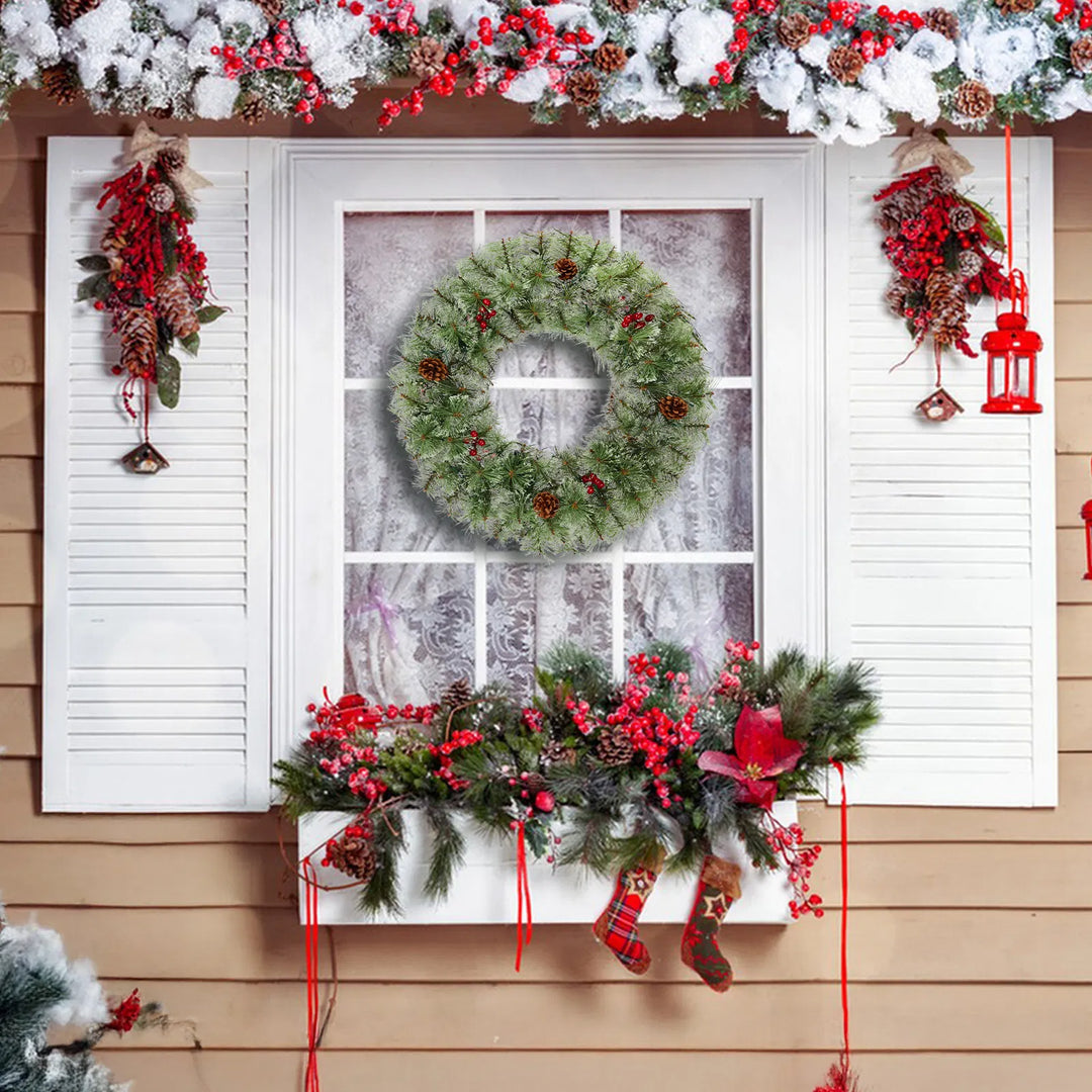 Two lit Christmas wreaths on a front door