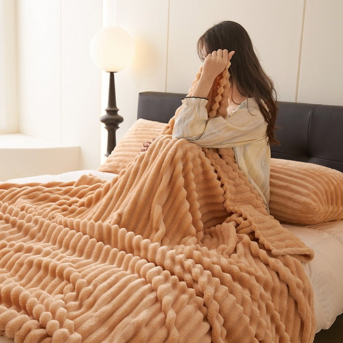 Ribbed faux rabbit fur blanket on bed