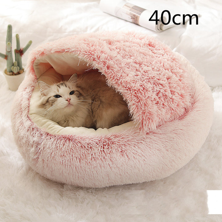 Cat curled up in a round plush bed with hood