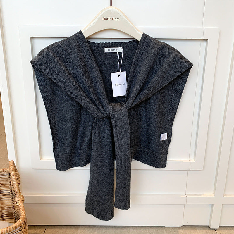Woman wearing a knit shoulder wrap