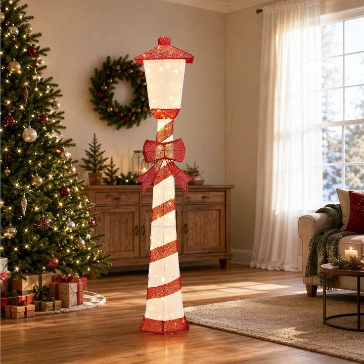 Lighted candy cane striped Christmas lamp post on a porch