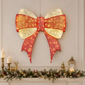 Large lighted red and gold Christmas bow