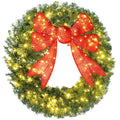 Giant lit Christmas wreath with red bow