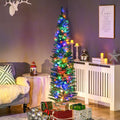 Green slim Christmas tree with multicolor lights