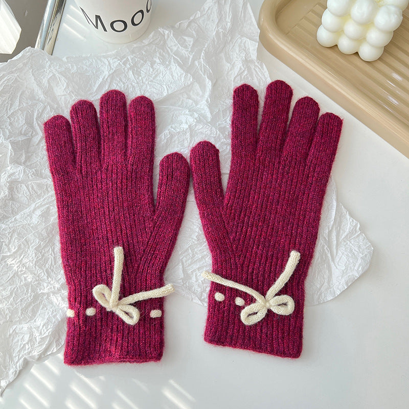 Pink ribbed knit gloves with bow
