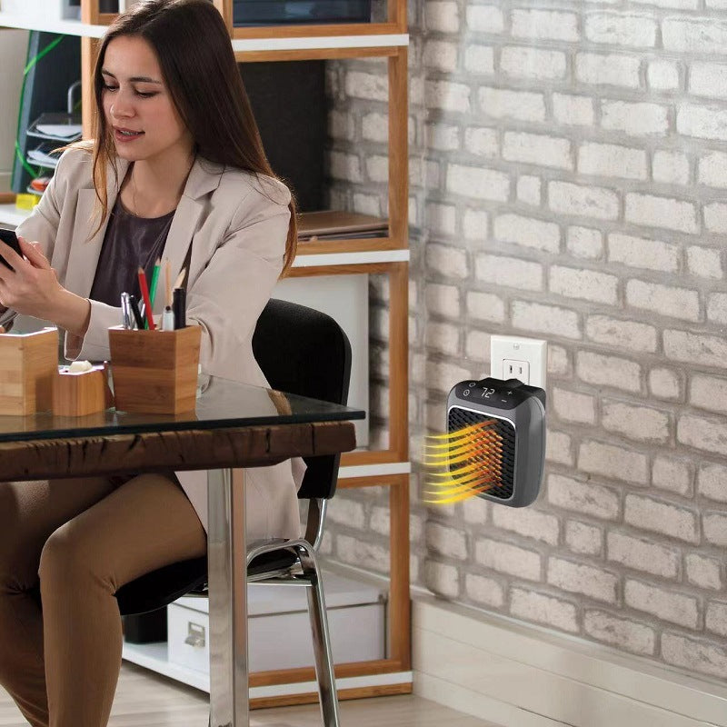 Compact gray heater plugged into a wall outlet
