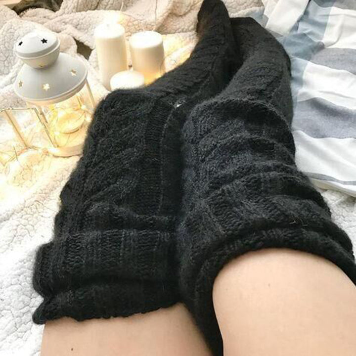 Woman wearing over-the-knee cable knit socks
