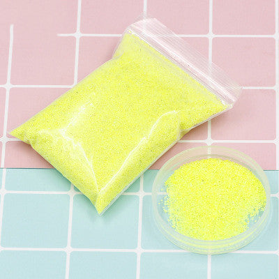 Colorful magic sand in water