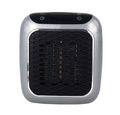 Compact gray heater plugged into a wall outlet