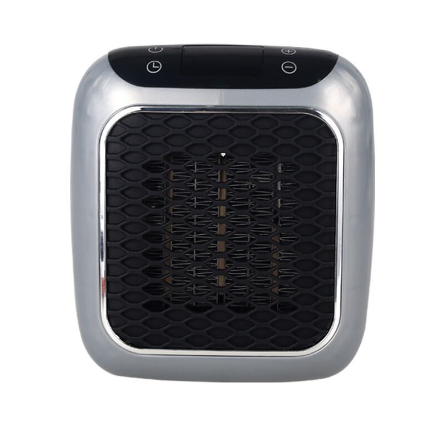 Compact gray heater plugged into a wall outlet
