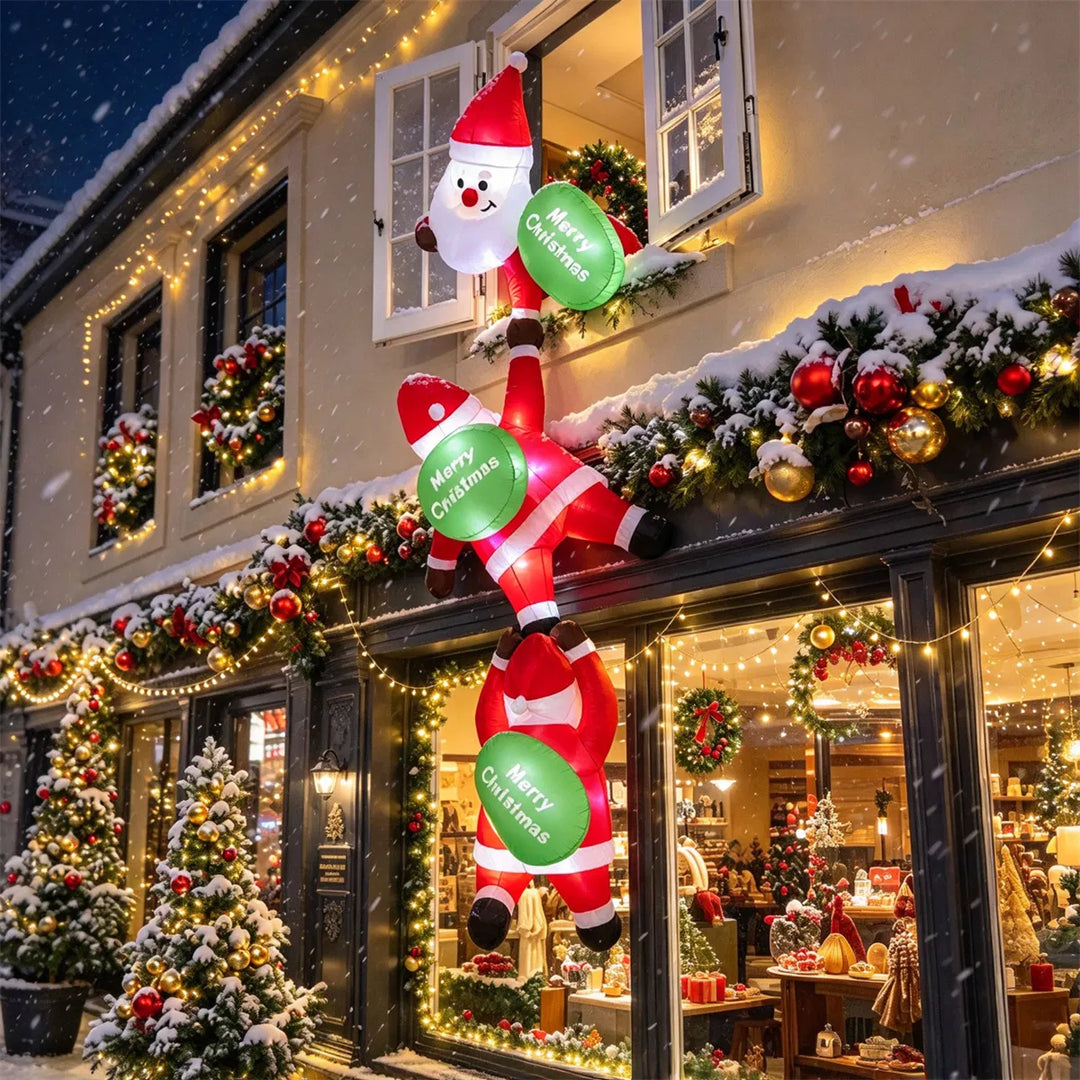 Three inflatable Santas climbing a balcony