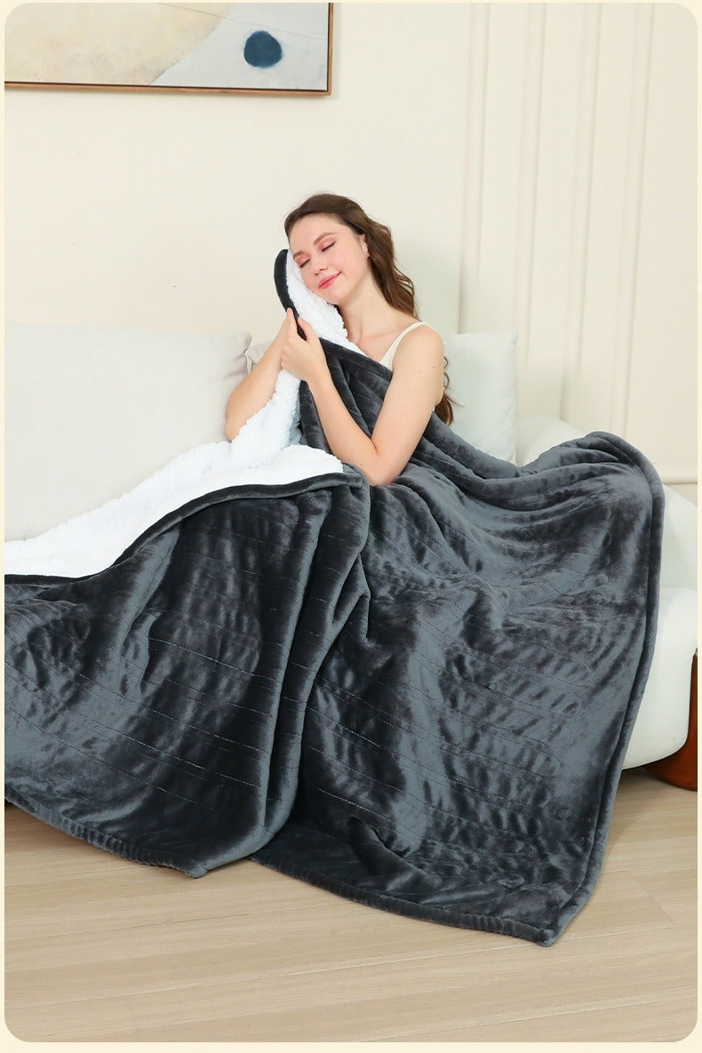 Electric heated flannel throw blanket on sofa