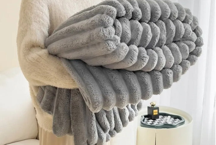 Ribbed faux fur blanket on a sofa