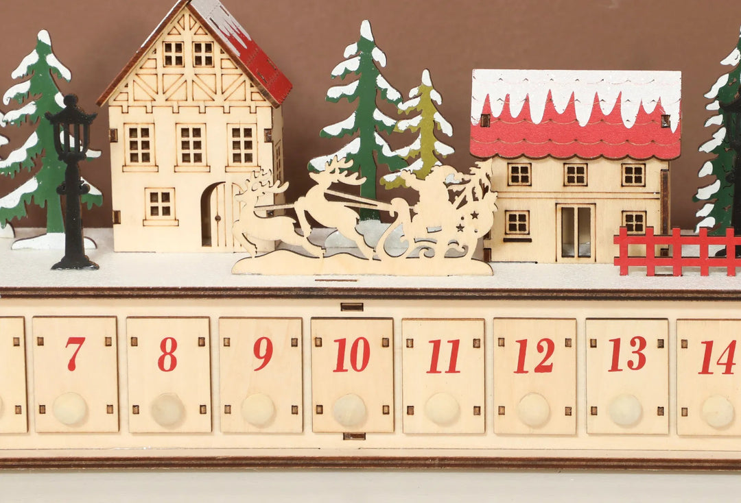 Long lighted wooden advent calendar on mantel