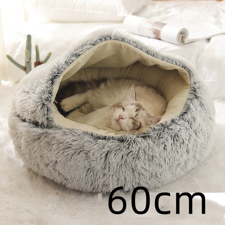 Cat curled up in a round plush bed with hood