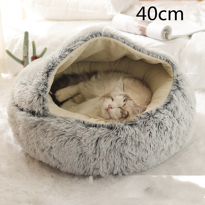 Cat curled up in a round plush bed with hood