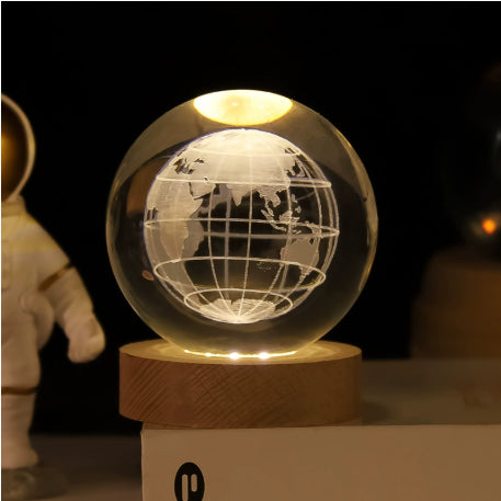 Glowing crystal ball with Saturn engraving