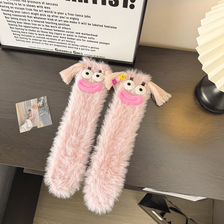 Fluffy green plush socks with googly-eyed monster faces