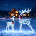 Two lighted glitter reindeer with red bows