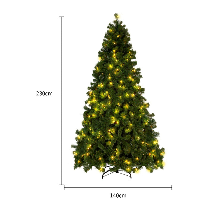 Snow-flocked white Christmas tree with warm-white lights