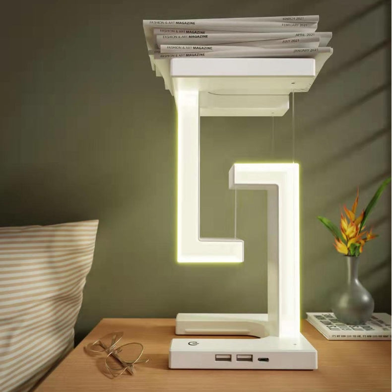 White floating lamp charging a phone