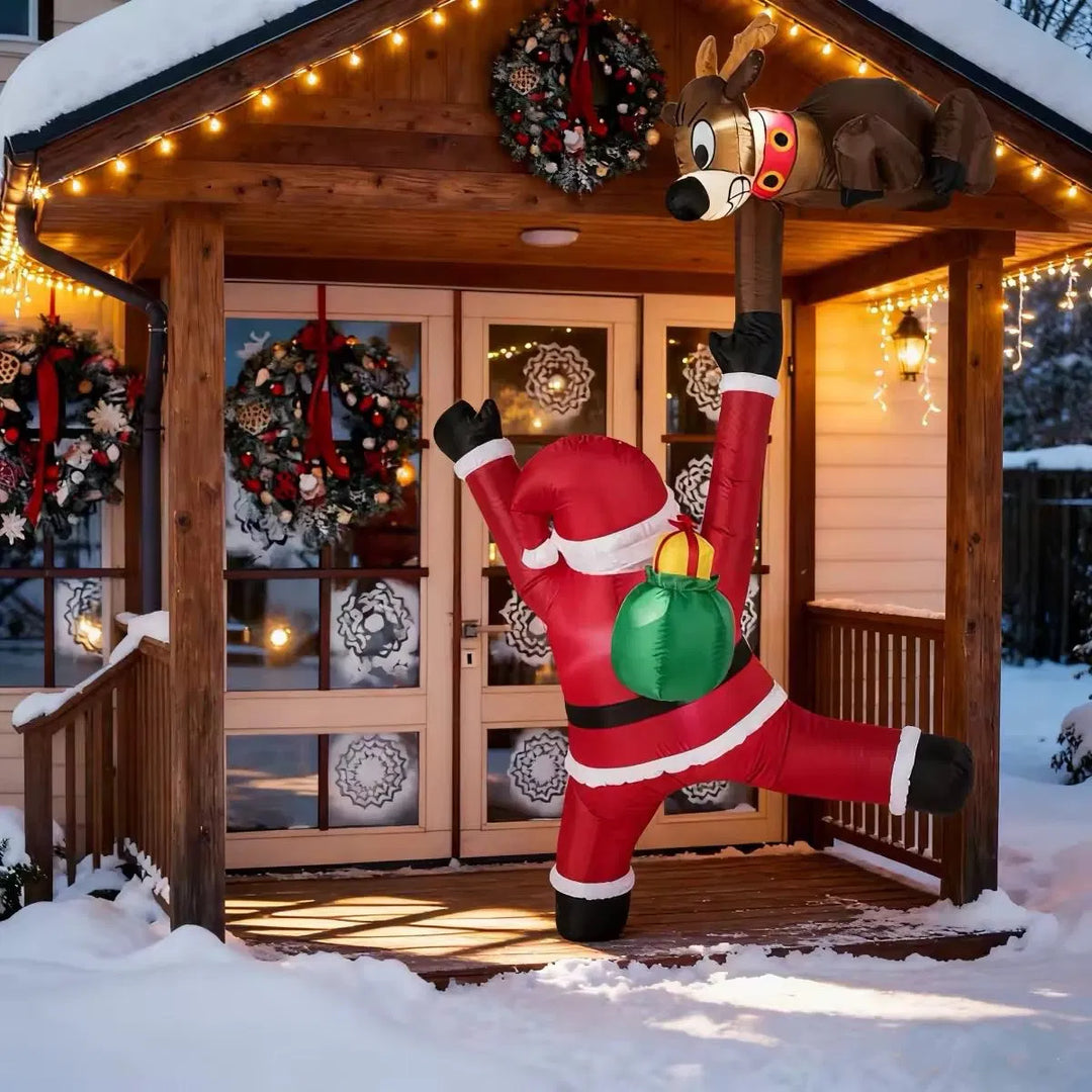 Inflatable climbing Santa and reindeer glowing outdoors