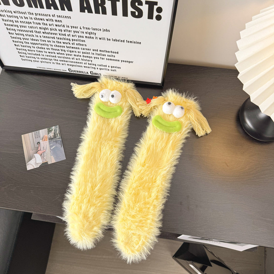 Fluffy green plush socks with googly-eyed monster faces