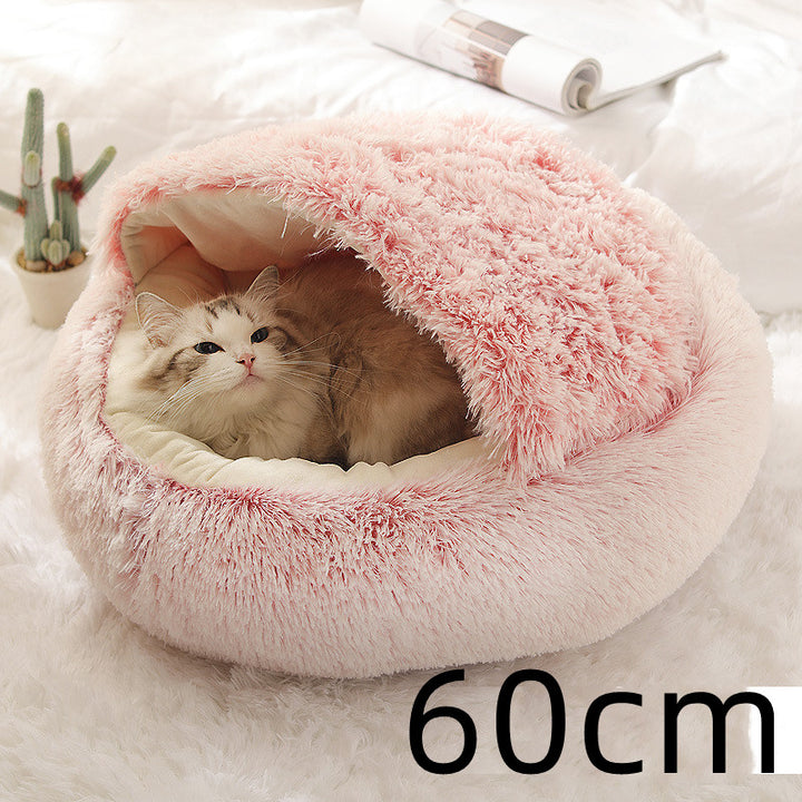 Cat curled up in a round plush bed with hood
