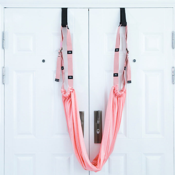 Woman stretching with a door yoga strap
