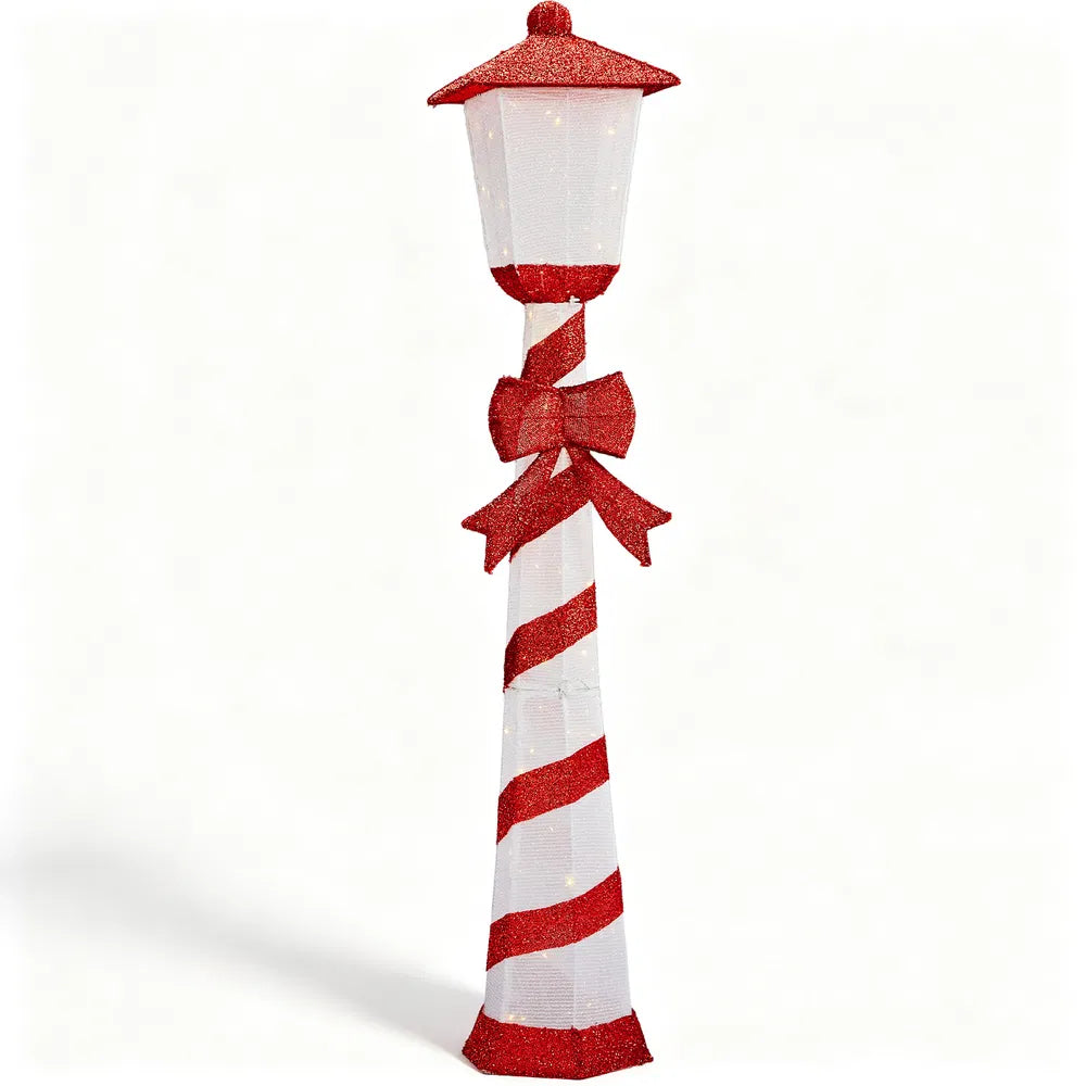 Lighted candy cane striped Christmas lamp post on a porch