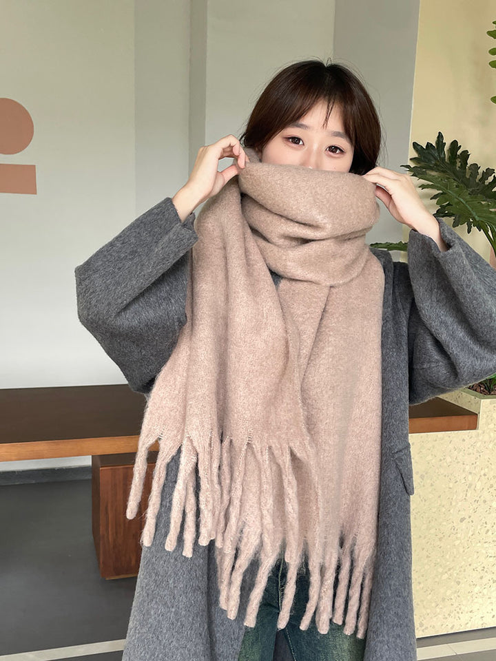 Woman wrapped in a fluffy oversized scarf