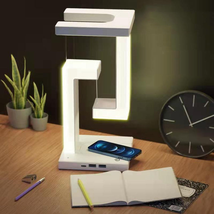White floating lamp charging a phone