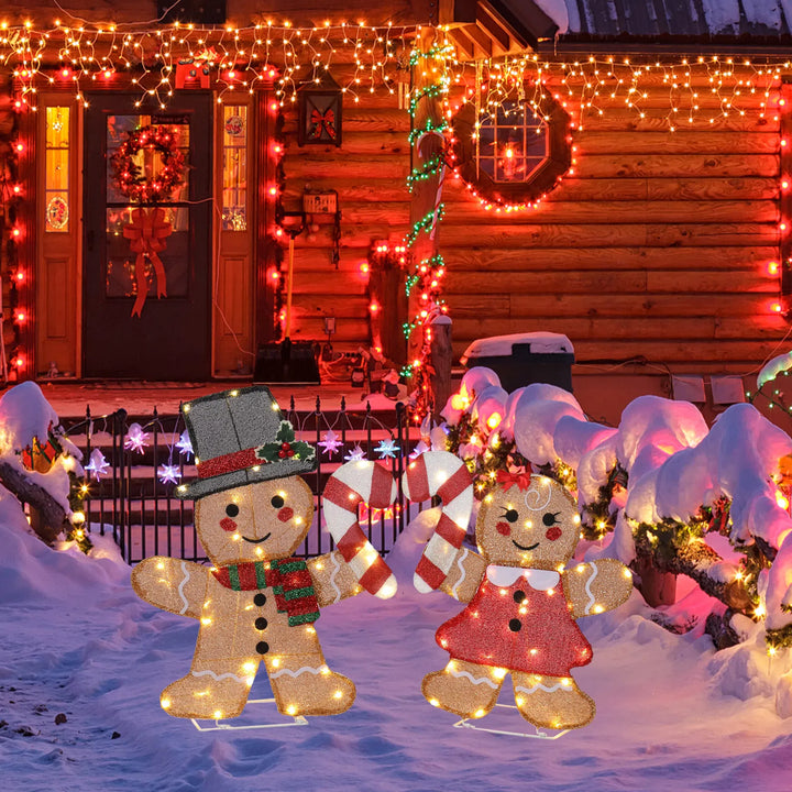 Two lighted gingerbread figures with candy canes